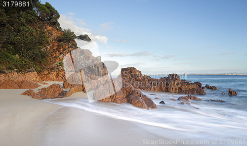 Image of Morning light glistens on the volcanic rocks at Shoal Bay