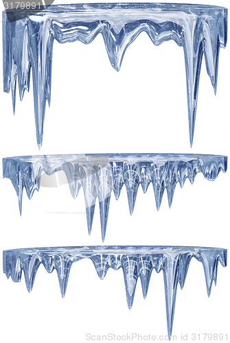 Image of set of hanging thawing icicles of a blue shade