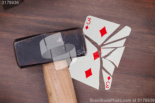 Image of Hammer with a broken card, three of diamonds