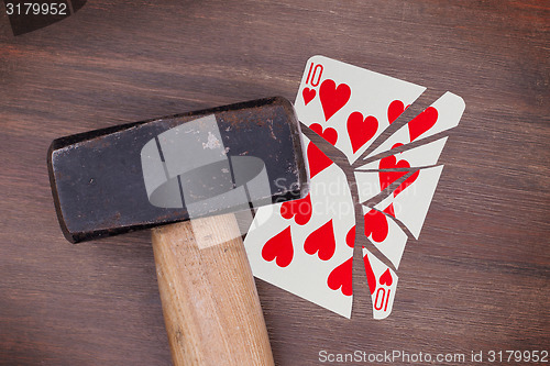 Image of Hammer with a broken card, ten of hearts