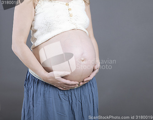 Image of Woman holding her baby bump
