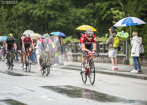 Image of Group of Cyclists Riding in the Rain