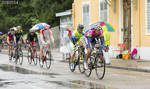 Image of Group of Cyclists Riding in the Rain