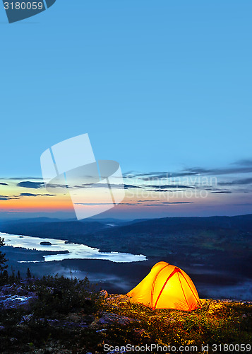 Image of A tent lit up at dusk