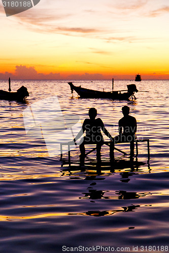 Image of sunrise people boat  and water in thailand  coastline south chin