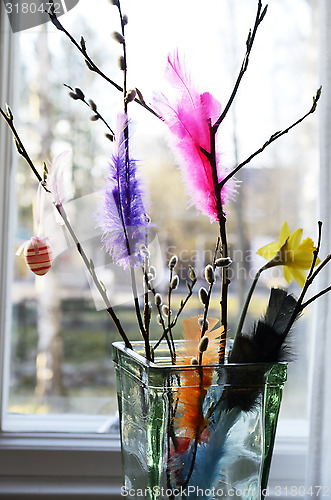 Image of Easter still life, willow branch and feathers in a vase