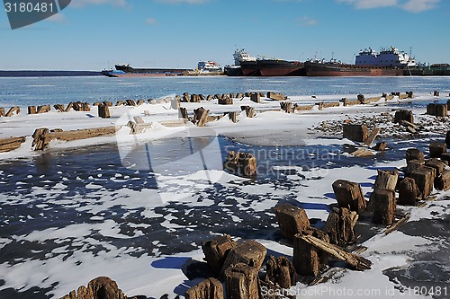 Image of remains of a wooden pier and ships in port