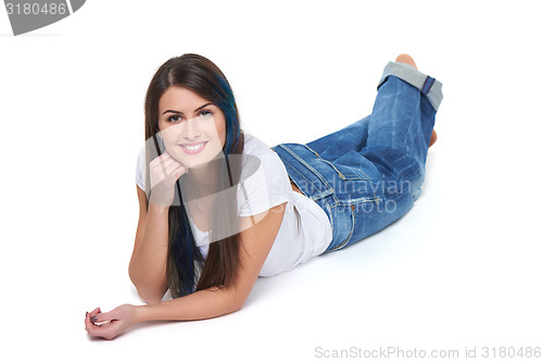 Image of Smiling beautiful woman lying on the floor