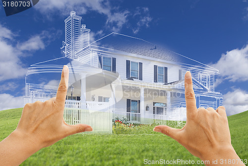 Image of Female Hands Framing House Drawing and House Above Grass