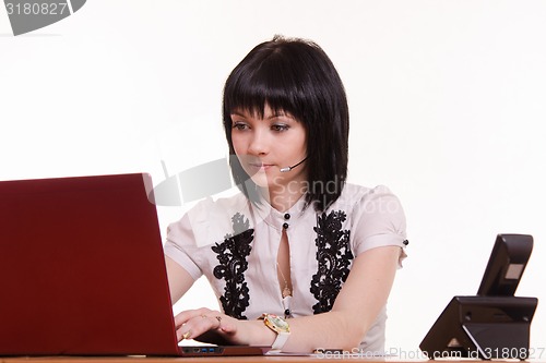 Image of Portrait of a call-center employee staring at the monitor