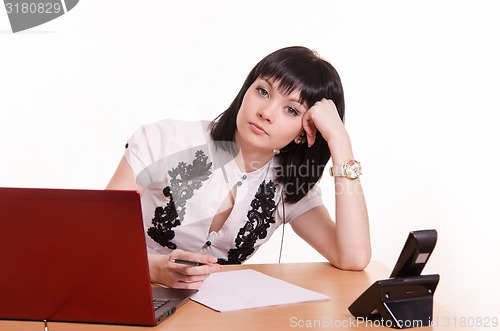 Image of Tired call-center employee leaned her head on 