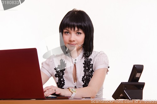 Image of Portrait of a call-center employee in front the monitor