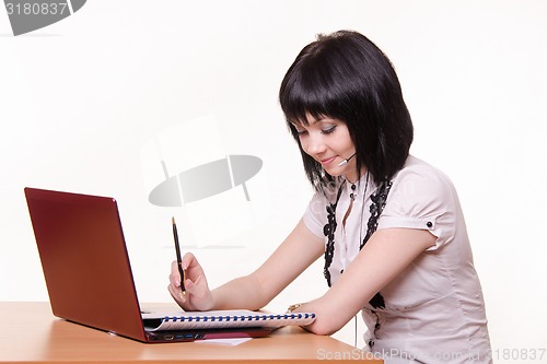 Image of Girl - call-center employee at the desk with documents