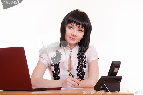 Image of Office employee call-center with pen in hand