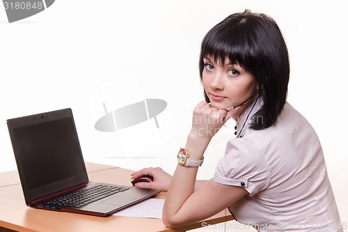 Image of Call-center worker at a table with laptop