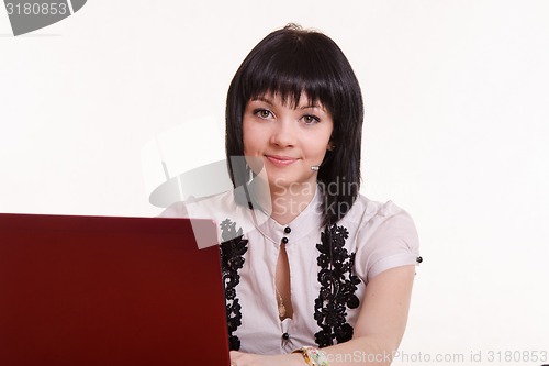 Image of Portrait of a smiling employee call-center front the monitor