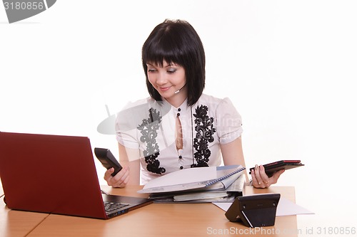 Image of Call-center worker with a phone in each hand