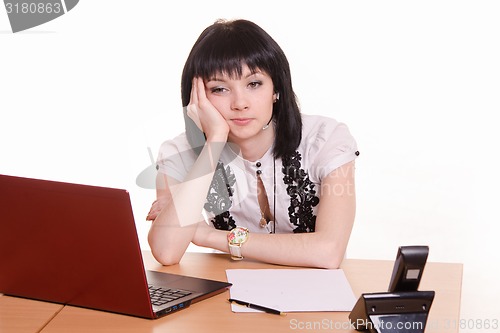 Image of Thoughtful, tired call-center employee in the office