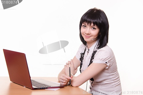 Image of Smiling girl - call-center employee at the desk