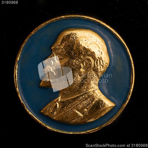 Image of Soviet badge Lenin golden relief on a blue background