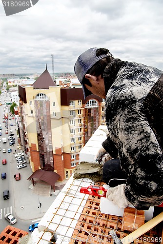 Image of Bricklayer on house construction