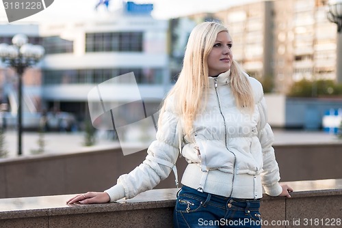 Image of Blond woman over urban background