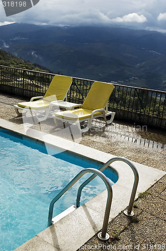 Image of Long chairs by the pool 3