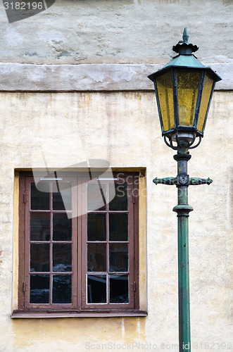 Image of Old lamp at an old facade