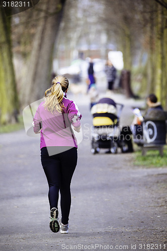 Image of Sized woman jogging in park