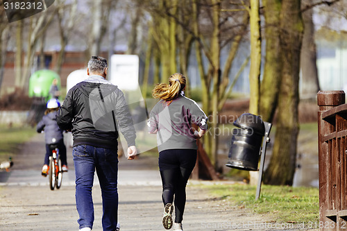 Image of Sized woman jogging in park