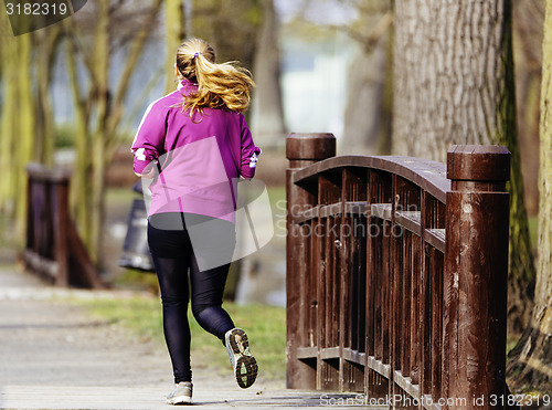 Image of Sized woman jogging in park