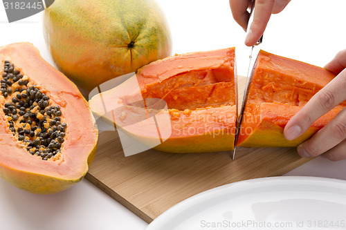 Image of First Cut Through A Hollowed Out Papaya Half
