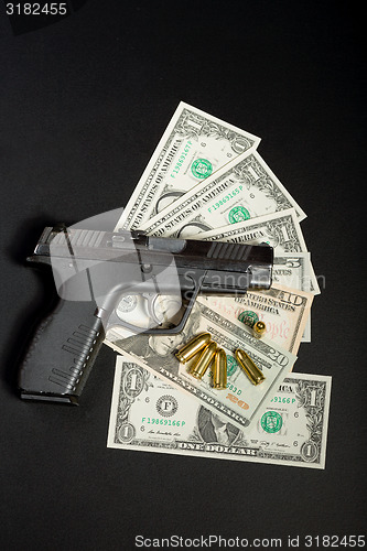 Image of gun with bullet on US dollar banknotes