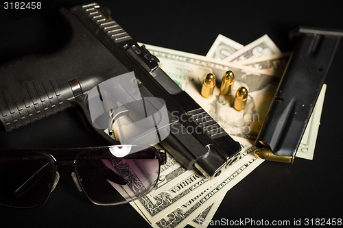 Image of gun with bullet on US dollar banknotes