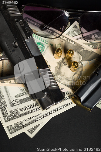 Image of gun with bullet on US dollar banknotes