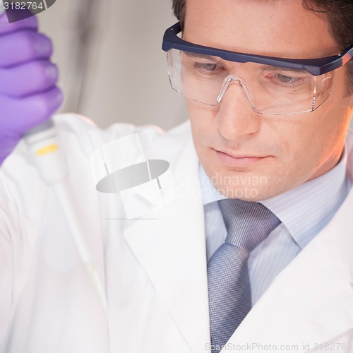 Image of Researcher pipetting in laboratory.