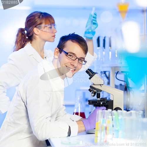 Image of Portrait of a young male researcher microscoping