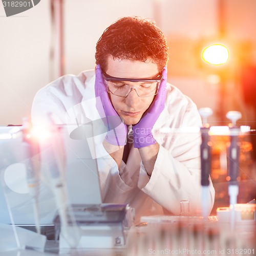 Image of Researcher sleeping at workplace.