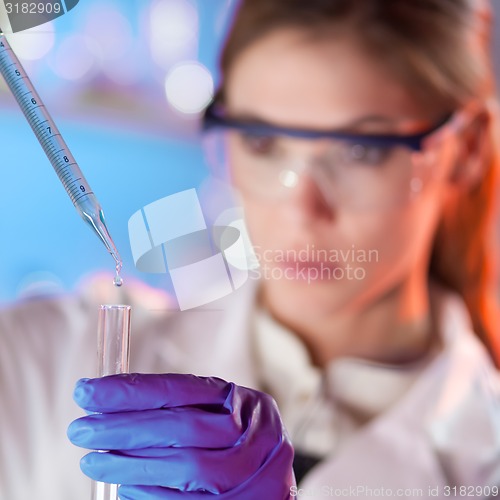 Image of Young scientist pipetting.