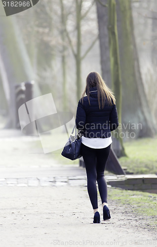 Image of young woman in spring in park