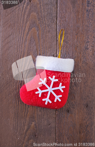 Image of red sock on wooden board