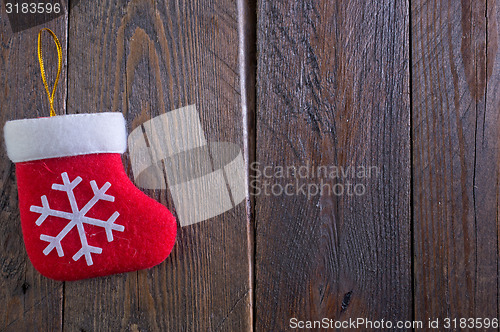 Image of red sock on wooden board