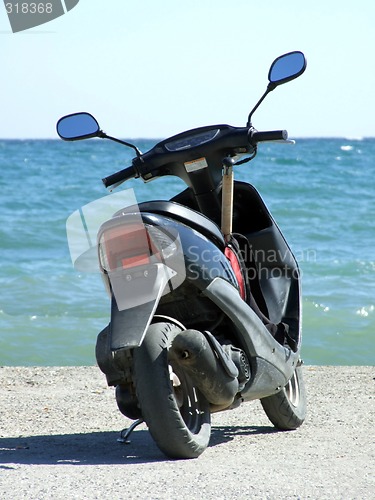 Image of motorbike on a mooring on a background of the blue sea