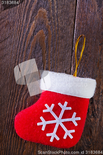 Image of red sock on wooden board