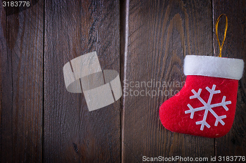 Image of red sock on wooden board