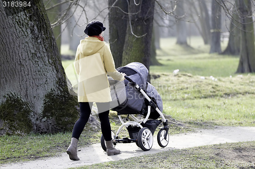 Image of Young mother with  pram 