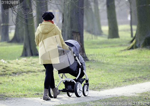 Image of Young mother with  pram 