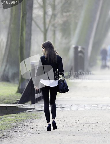 Image of young woman in spring in park