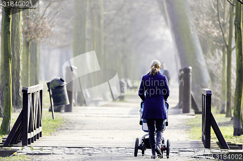 Image of Young mother with  pram 