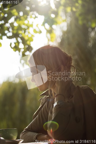 Image of portrait of a beautiful young woman in park.